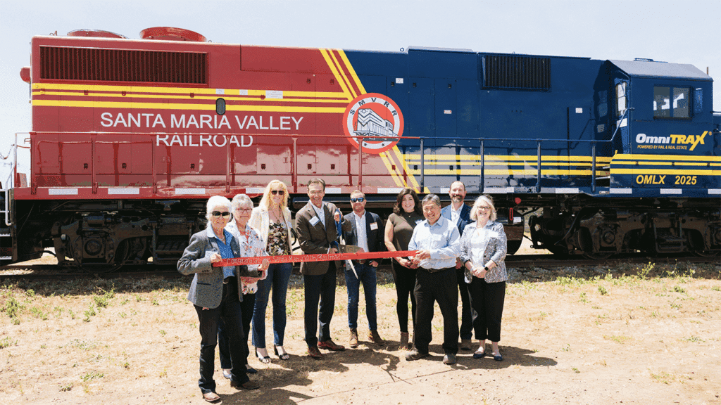 State and local partners join OmniTRAX officials to commemorate the new joint venture partnership operating the Santa Maria Valley Railroad. Left to Right: Alice Patino (Mayor of Santa Maria, Calf.), Vicki Conner (EconAlliance, Initiatives Director), Suzanne Singh (Santa Maria Chamber of Commerce, VP of Economic Development and Government Affairs), Dean Piacente (OmniTRAX, CEO), Scott Remington (OmniTRAX, Vice President, Corporate Development), Belinda Popovich (Santa Maria Valley Railroad, Assistant General Manager), Rob Himoto (Santa Maria Valley Railroad, President), Bob Nelson (County of Santa Barbara, Fourth District Supervisor), and Jenelle Osborne (EconAlliance, CEO). (Photograph Courtesy of OmniTrax)